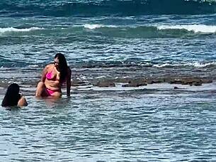 Two beautiful Brazilian women enjoy their first time kissing and exploring on the sunny beach. Their curvy bodies shine under the sun in this outdoor adventure.
