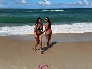 Two beautiful Brazilian women enjoy their first time kissing and exploring on the sunny beach. Their curvy bodies shine under the sun in this outdoor adventure.