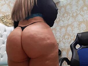 Sexy mature blonde dances sensually in shorts, shaking her big ass.