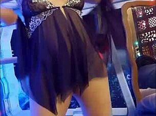 The redhead woman dances in purple chemise while using toys at home.