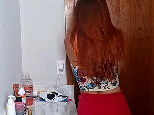 An older man unexpectedly joins a young redhead in the bathroom, exploring submissive ass worship in pantyhose.