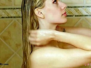 Blonde aspiring model takes refreshing shower during photoshoot session