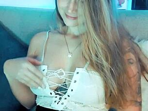 The cute cosplay girl in costume smiles sweetly on webcam like a playful whore.