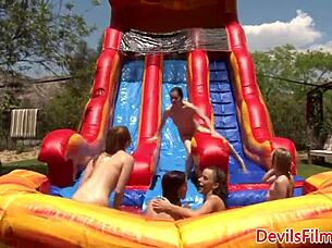 Lesbian beauties are out in the open, toying and licking each other's shaved pussies with strapons.