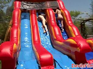 Lesbian beauties are out in the open, toying and licking each other's shaved pussies with strapons.