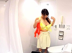 Japanese model with huge saggy tits changes clothes in a hidden camera capture.