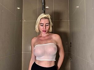 hey, check out this blonde babe with huge tits getting wet in shower