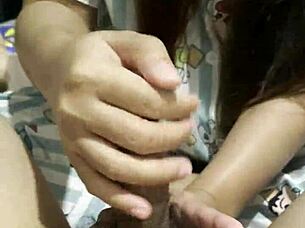 asian girl gives her boyfriend an amazing handjob in bedroom 🍆✋