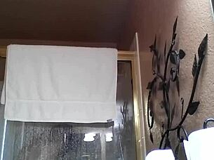 An Asian amateur enjoys a relaxing shower during bath time.