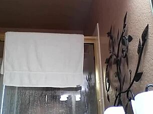 An Asian amateur enjoys a relaxing shower during bath time.