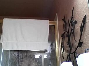 An Asian amateur enjoys a relaxing shower during bath time.