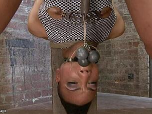 Lesbian ebony gets spanked and fucked with strapon in bondage