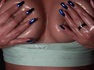 close up on long blue nails and big natural tits with cum