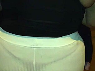 Mature woman with big ass walks down the street in thong under transparent leggings.