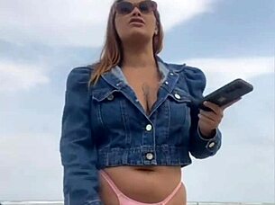 On the beach, she flashed him until he got rock hard, then grabbed and felt his impressive size for herself.