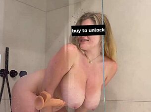 curvy blonde beauty teases in the shower, plunging a huge dildo deep for intense solo pleasure