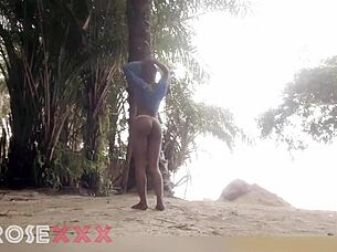 black girl teases playfully on the beach in a homemade couple scene