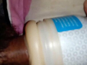 Someone explores using a sex toy for personal pleasure in a simple setting.