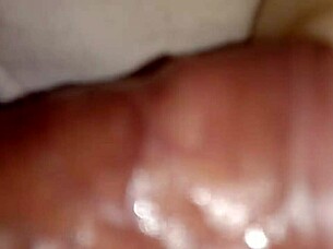 Someone explores using a sex toy for personal pleasure in a simple setting.