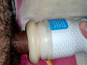 Someone explores using a sex toy for personal pleasure in a simple setting.