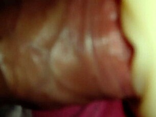 Someone explores using a sex toy for personal pleasure in a simple setting.