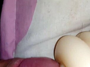 Someone explores using a sex toy for personal pleasure in a simple setting.