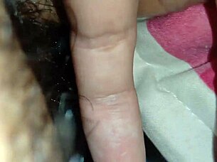 Someone explores using a sex toy for personal pleasure in a simple setting.