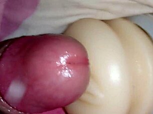 Someone explores using a sex toy for personal pleasure in a simple setting.