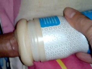 Someone explores using a sex toy for personal pleasure in a simple setting.