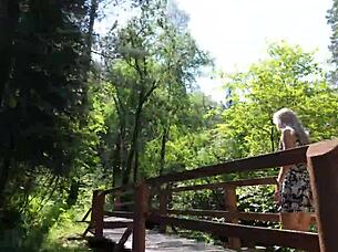Sweet girl uses remote controlled device in park and reaches peak excitement