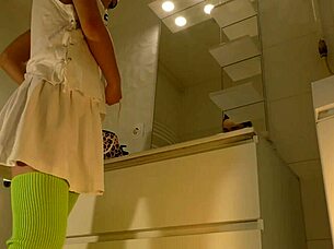 Hot brunette college girl flashes panties under mini tennis skirt in bathroom.