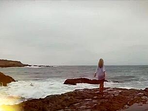 Cindy Dollar slips out of her red dress outdoors. She teases her shaved pussy with a powerful dildo until orgasm hits.