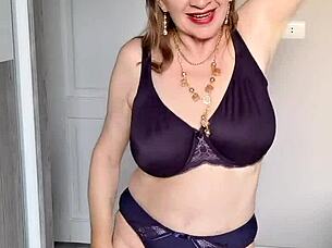 a busty mature milf in lingerie and stockings reveals her shaved pussy in closeup while masturbating passionately at home