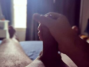 Solo guy masturbates his big cock with sun rays streaming through the bedroom window