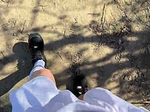 young petite girl in fishnets and skirt fishes outdoors after school