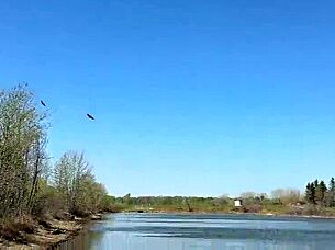 young petite girl in fishnets and skirt fishes outdoors after school