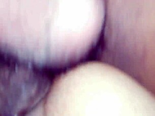 An amateur couple engages in a position from behind during their intimate time.