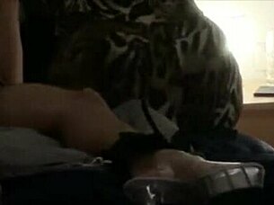 Two dominant figures engage in an activity involving a bound participant who receives a specific treatment.