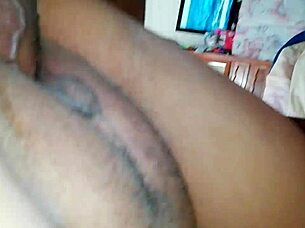 An amateur couple engages in a position from behind during their intimate time.