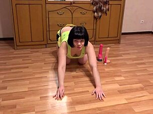 Brunette performs solo masturbation using toys for anal penetration showcasing athletic skills and hairy details.