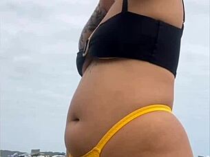 Wearing A Tight Yellow Bikini That Splits The Pussy To Attract Attention On The Beach