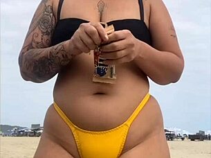 Wearing A Tight Yellow Bikini That Splits The Pussy To Attract Attention On The Beach
