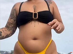 Wearing A Tight Yellow Bikini That Splits The Pussy To Attract Attention On The Beach