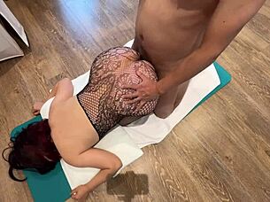 Curvy woman wears black fishnet stockings in a casual POV style