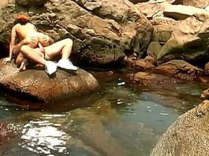 A horny mature guy pounds exotic babe in cap and shades on seaside rocks 💦👓