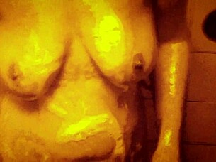 Seductive slow motion shower reveals wet glistening curves