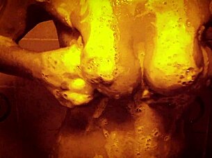 Seductive slow motion shower reveals wet glistening curves