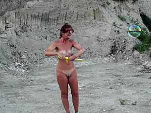 Naked milf wife covers herself in soap bubbles outdoors for amateur fun