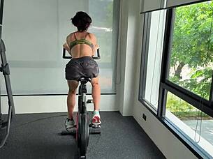 muscular brunette strips naked after sweaty gym workout