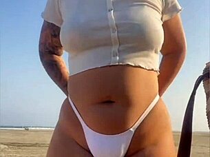 redhead flashes swollen pussy lips on beach